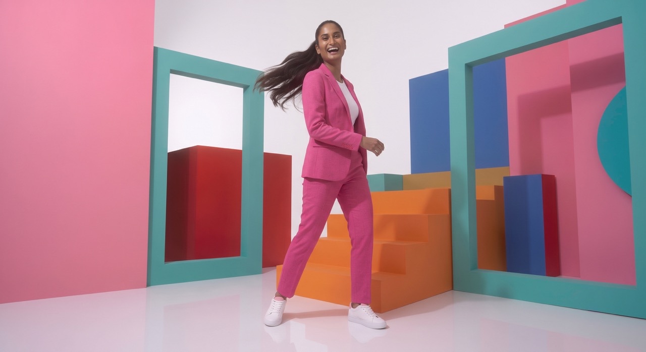 Happy Indian Fashion Model Walking in Pink Suit | Royalty-Free image | Pixlaris