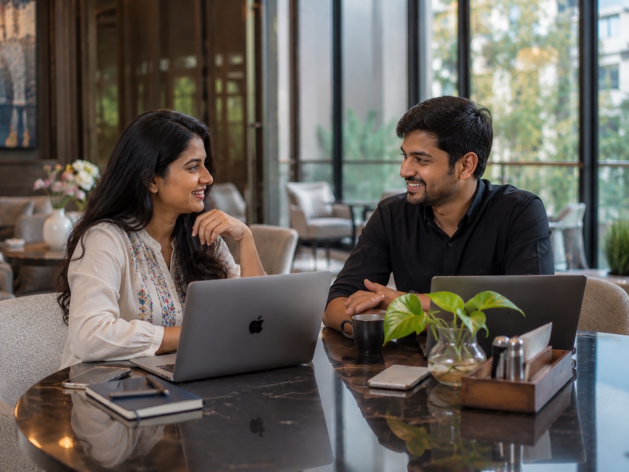 Indian Business Professionals Meeting in Modern Cafe with Laptops for Team Collaboration  Large