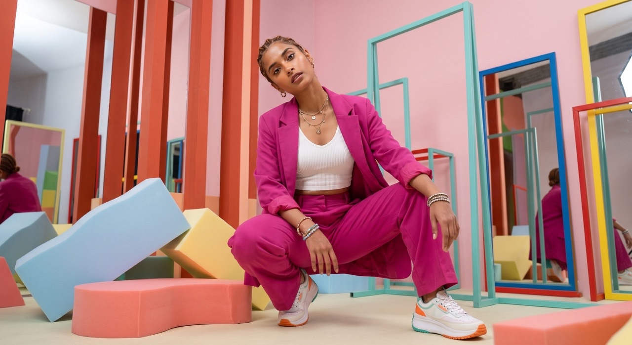 Creative Squat Pose in Pink Power Suit | Royalty-Free image | Pixlaris