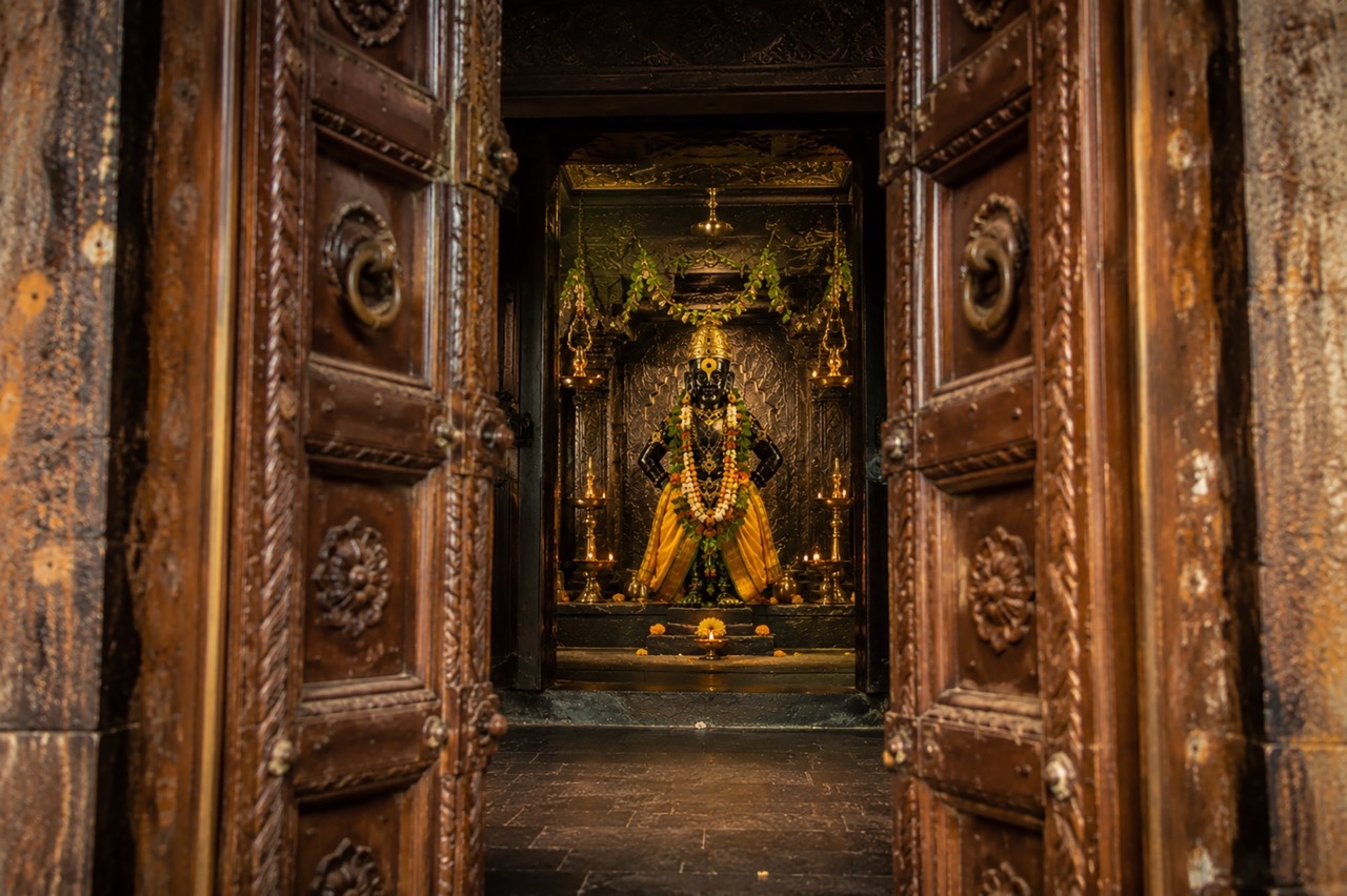 Lord Vitthal Idol Viewed Through Ancient Temple Doors | Royalty-Free image | Pixlaris