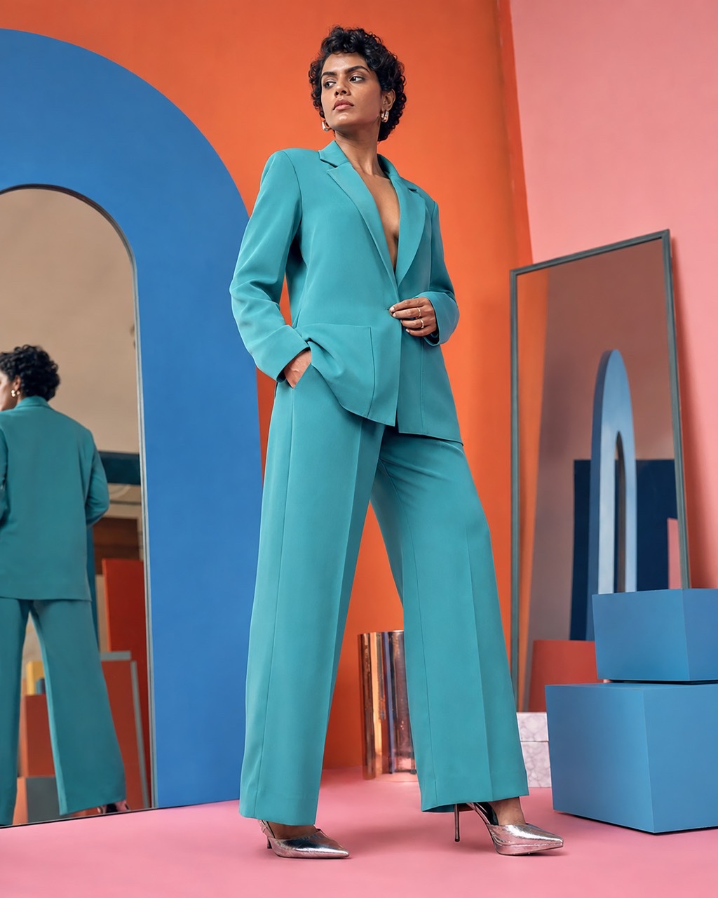 Low Angle Fashion Portrait of Woman in Turquoise Power Suit | Royalty-Free image | Pixlaris