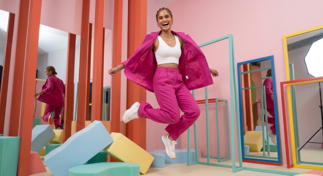 Joyful Fashion Model Jumping in Pink Pantsuit | Royalty-Free image | Pixlaris